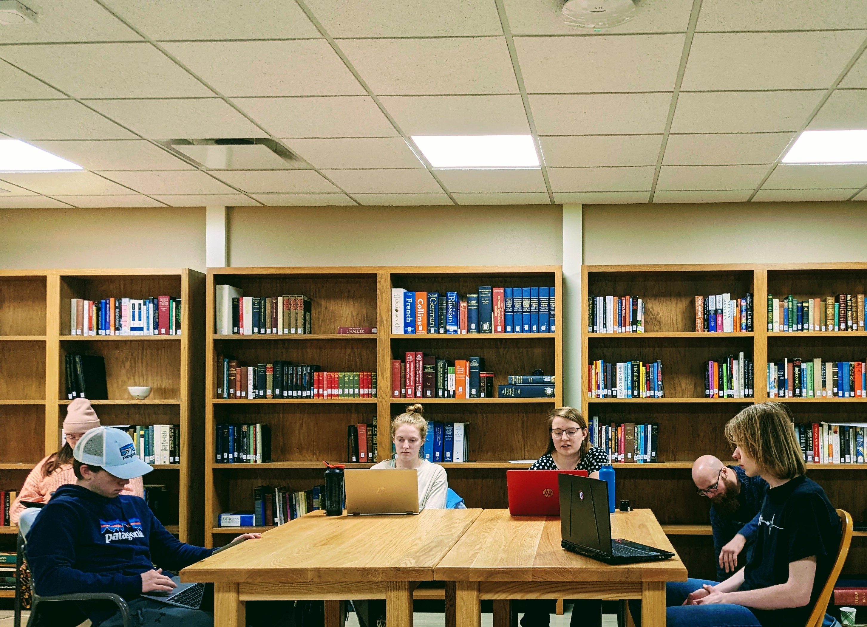 Students gathered around a table in a library setting