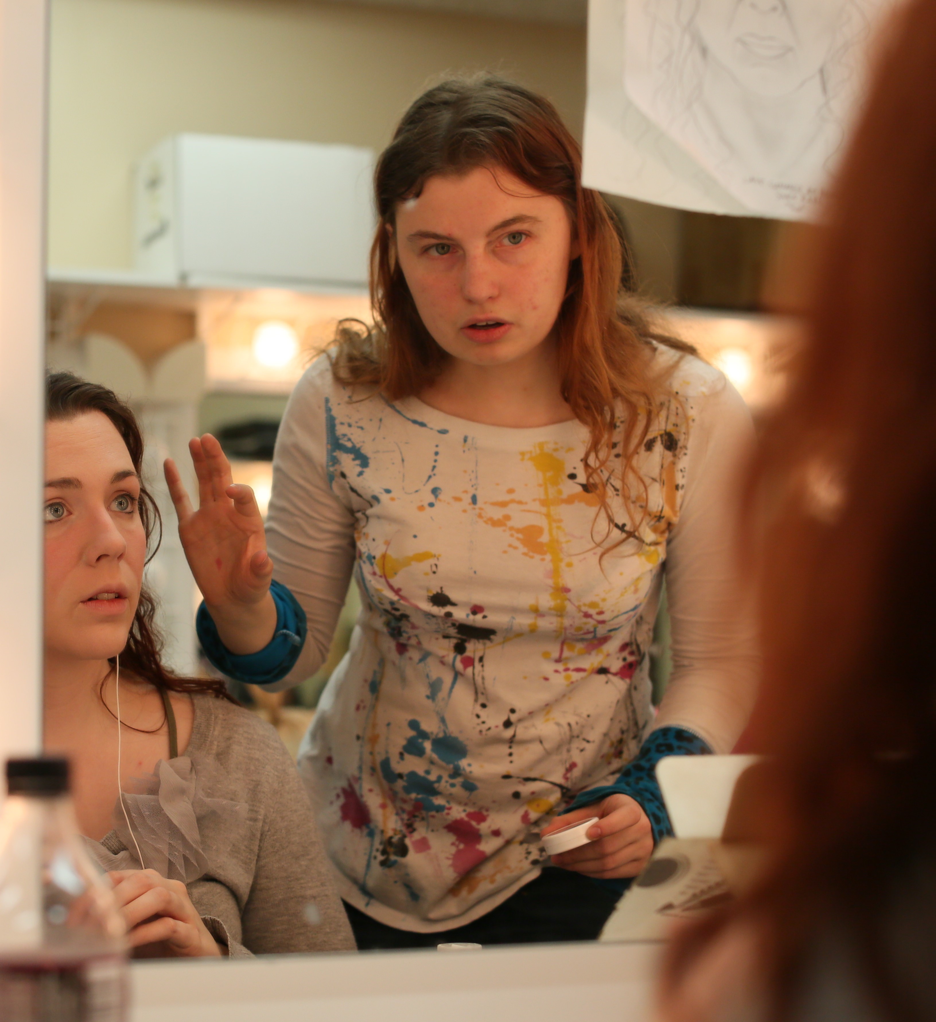 Makeup artist student applying makeup to student actress