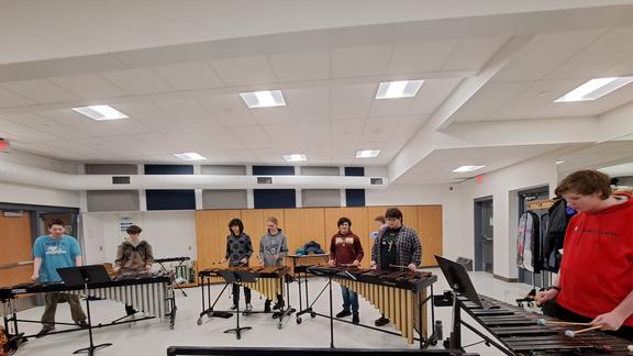 Students play percussion during outreach session with Dr. Henry Eichman.