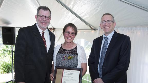 Photo of Lisa Fizpatrick with her award, University President Eric Kaler, and Professor William Tolman