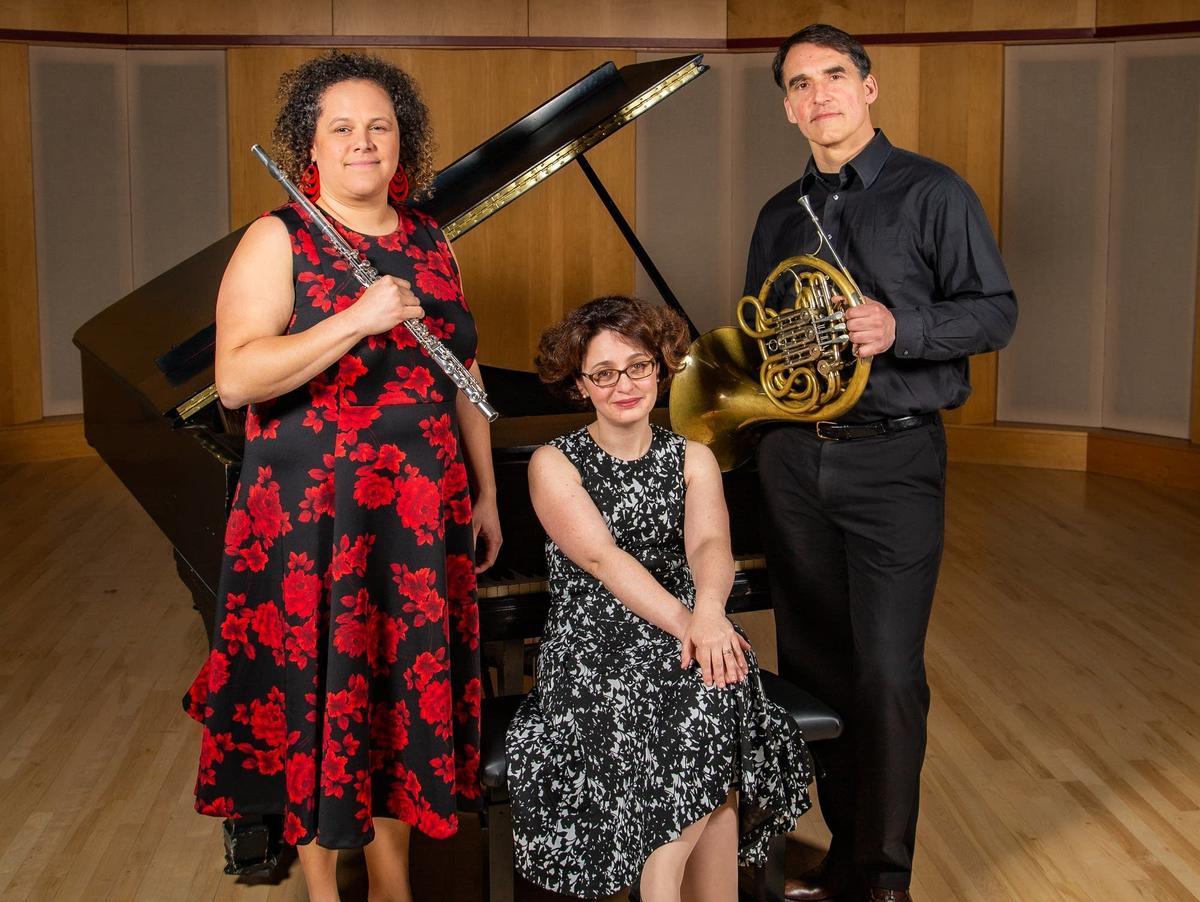 three musician professors posing on Weber Music Hall stage with their instruments