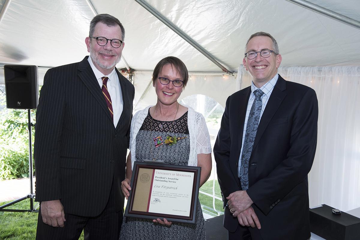 Photo of Lisa Fizpatrick with her award, University President Eric Kaler, and Professor William Tolman