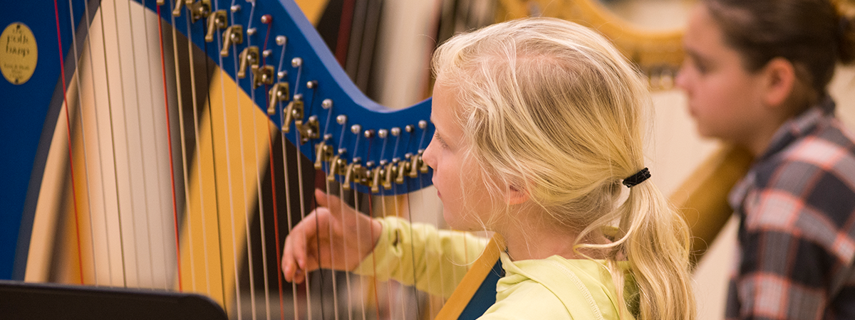 young girl playing harp